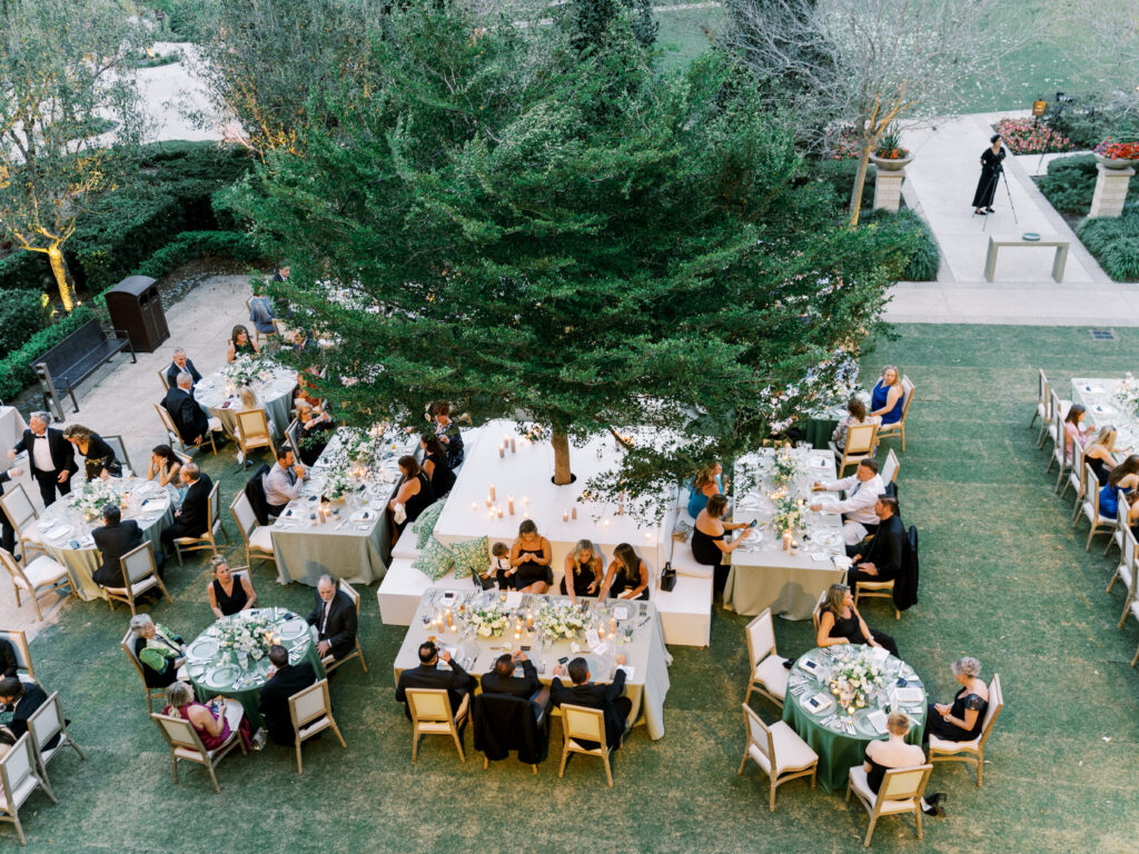 Luxury destination wedding reception setup with custom floral design and candlelit tablescape